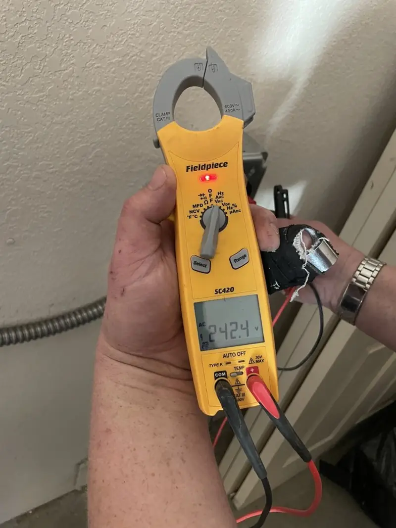 Voltage testing with clamp meter during Recessed Lighting Installation in Nashville